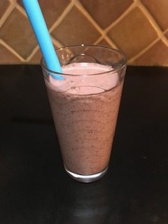 berry spinach smoothie with straw